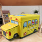 School Bus Toy Storage Box by Dollamis, partially open, showcasing its vibrant design.