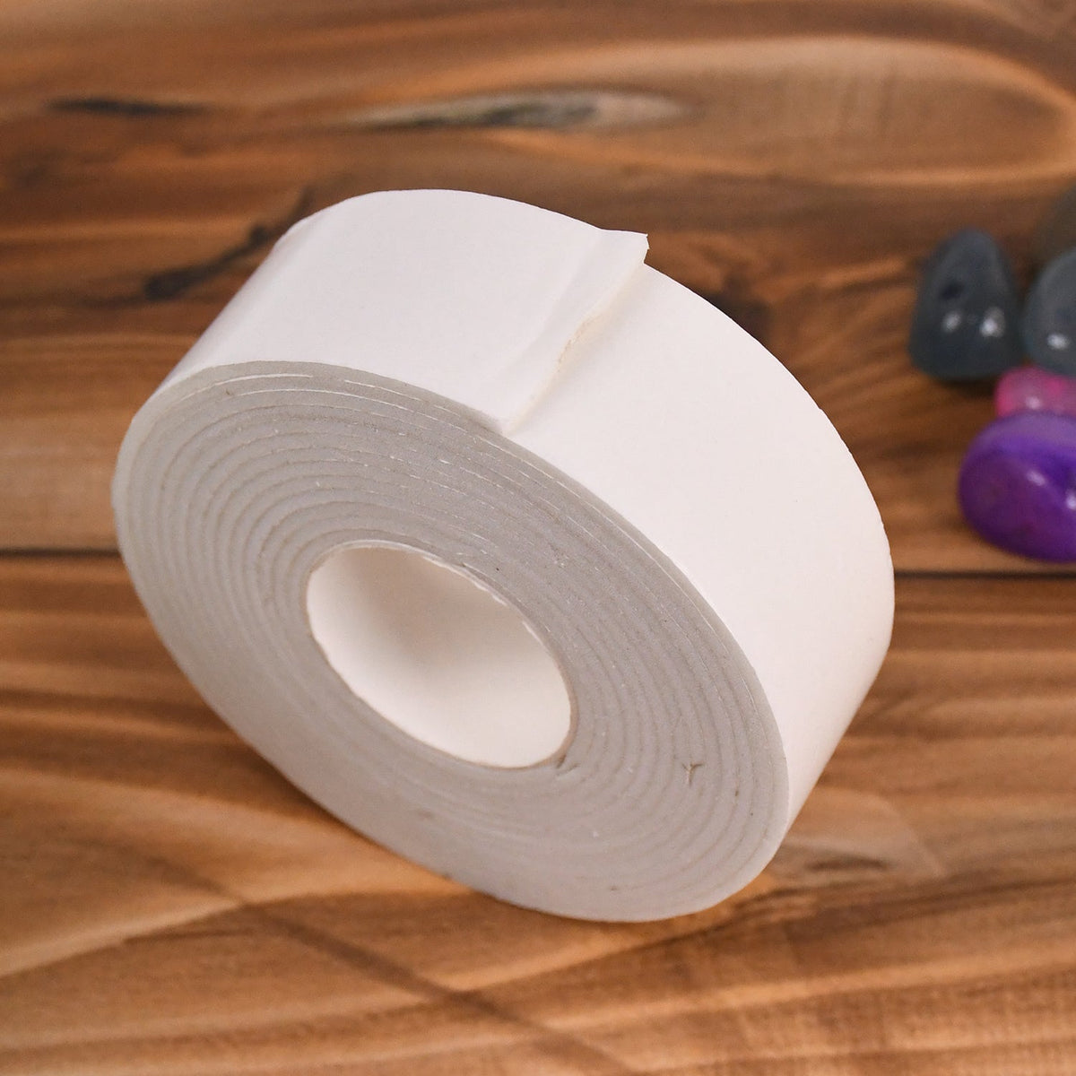 Double sided foam tape firmly securing items on a smooth wall surface
