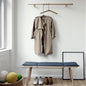 Single wooden clothes hanger with a notched design for coats and suits.