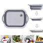 Multi-function foldable chopping board in use for washing vegetables.