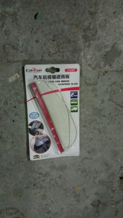 Rear view of car side mirror with a rainproof cover accessory installed.
