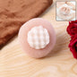 Soft exfoliating round bath scrubber with foam grip creating rich lather