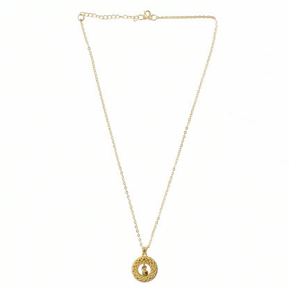 detailed close-up of golden pendant showing fine intricate patterns