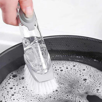 Hand demonstrating the controlled soap dispensing action of the dish brush