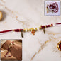 Ganesh charm rakhi with feather pendants on beaded thread
