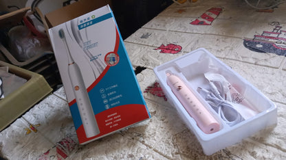 Detailed view of the Electric Toothbrush head, showing bristles and tongue cleaner.